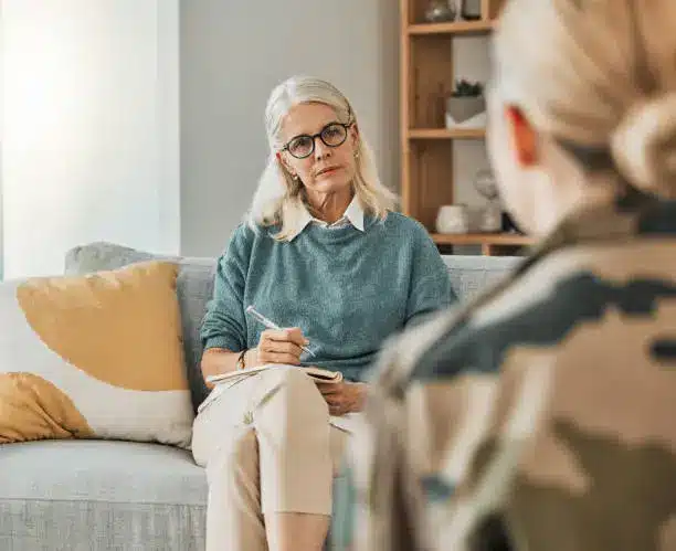 Designer taking notes while listening to a homeowner during an in-home consultation.