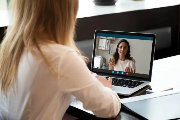 Homeowner meeting with a holiday designer during a virtual consultation via video call.