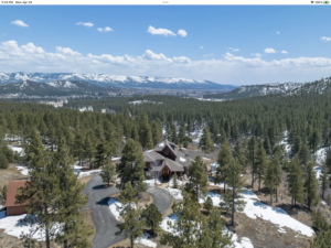 Aerial view of a luxury mountain home surrounded by dense pine forest near Durango, Colorado - illustrating the wildfire risk context for homes in the Colorado mountain landscape