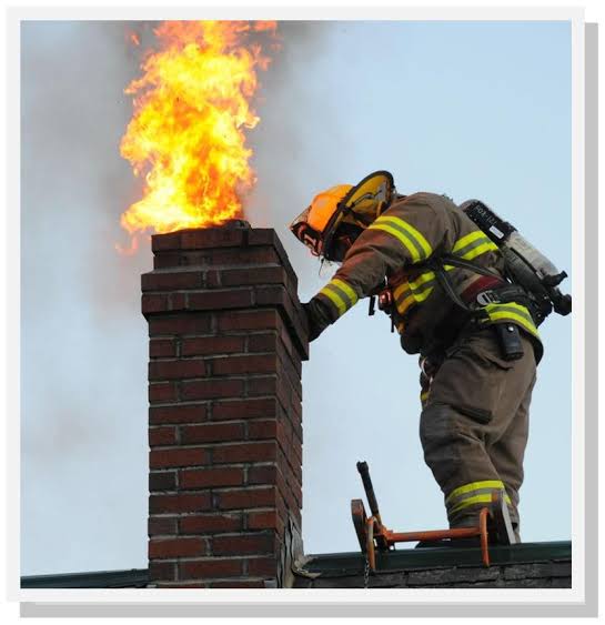 Firefighter on roof responding to a chimney fire